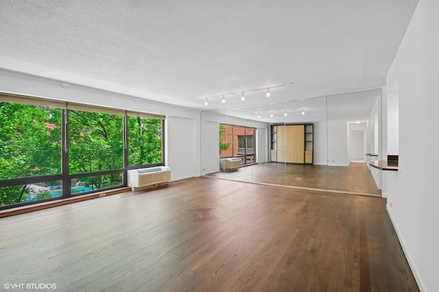 1169 S Plymouth Ct Unit 406, Chicago, IL 60605 - unfurnished living room with a wall mounted air conditioner and wood finished floors