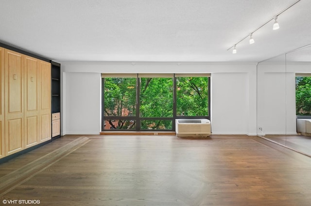 1169 S Plymouth Ct Unit 406, Chicago, IL 60605 - unfurnished living room featuring a wall mounted AC and wood finished floors