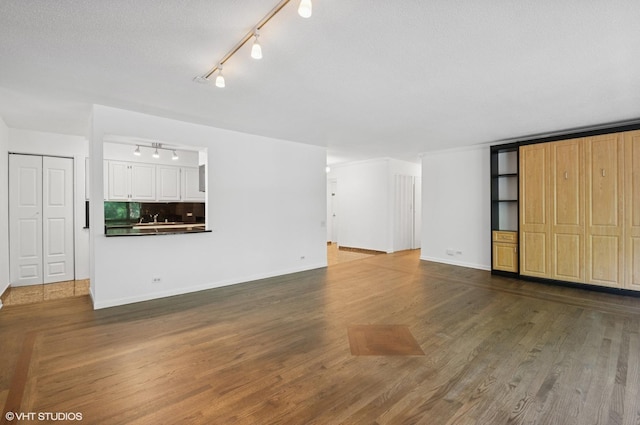 1169 S Plymouth Ct Unit 406, Chicago, IL 60605 - unfurnished living room with track lighting and wood finished floors