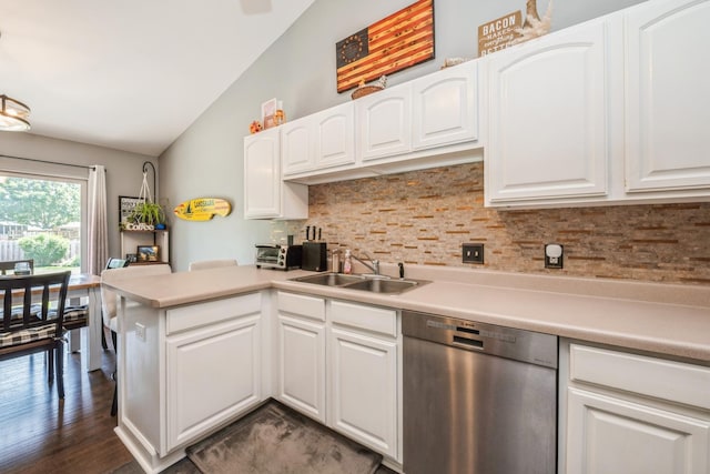5705 Cobblestone Trl, Mchenry, IL 60050 - kitchen featuring stainless steel dishwasher, vaulted ceiling, backsplash, a peninsula, and white cabinets