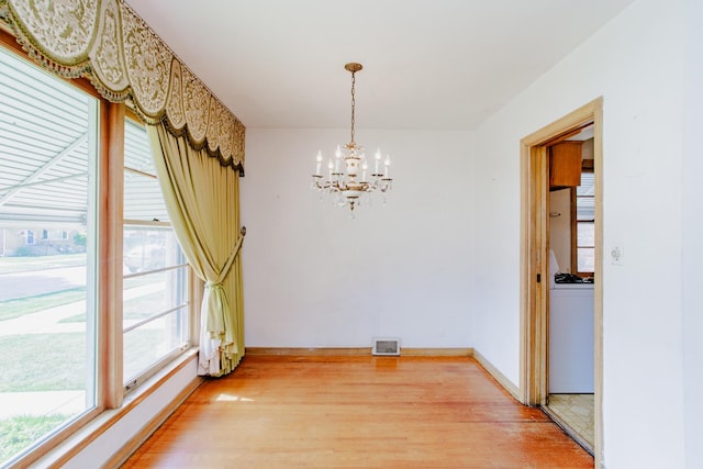 7320 N Oriole Ave, Chicago, IL 60631 - unfurnished dining area with a chandelier and light wood-style floors