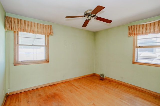 7320 N Oriole Ave, Chicago, IL 60631 - empty room featuring light wood-style floors, healthy amount of natural light, and ceiling fan