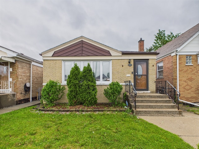 4931 S Knox Ave, Chicago, IL 60632 - view of front facade with brick siding, a chimney, and a front yard