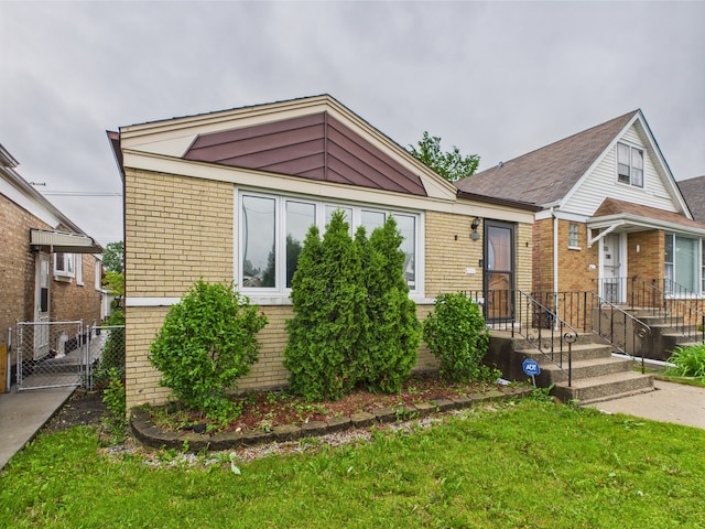 4931 S Knox Ave, Chicago, IL 60632 - view of front of home featuring brick siding, a gate, and a front lawn