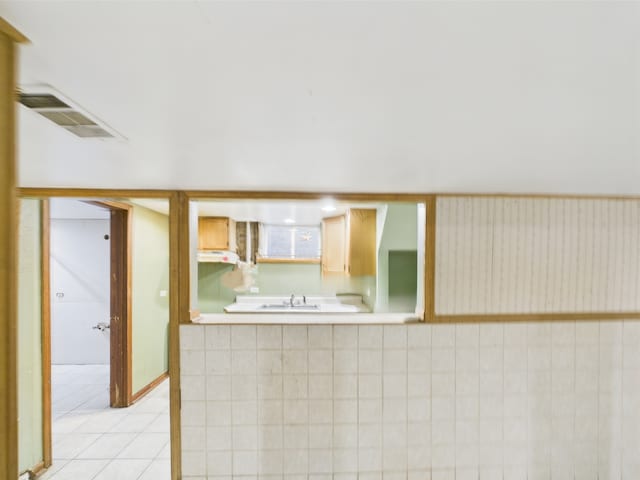 4931 S Knox Ave, Chicago, IL 60632 - kitchen featuring light tile patterned floors, light countertops, and under cabinet range hood