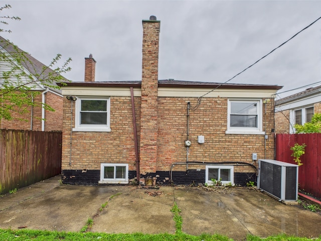 4931 S Knox Ave, Chicago, IL 60632 - rear view of property featuring a chimney, brick siding, and a patio area