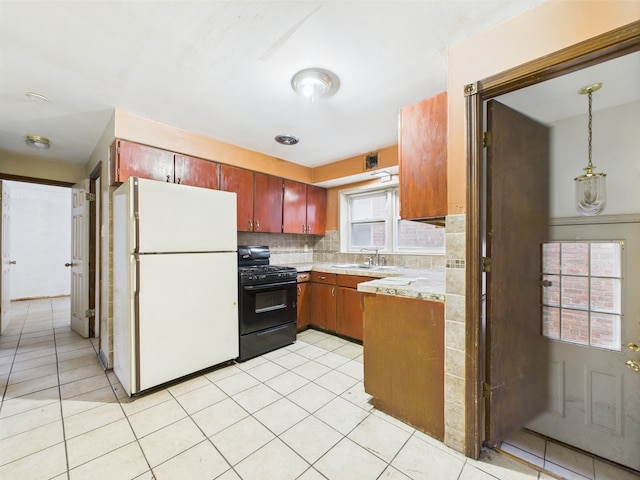 4931 S Knox Ave, Chicago, IL 60632 - kitchen with freestanding refrigerator, black range with gas stovetop, light countertops, light tile patterned floors, and tasteful backsplash