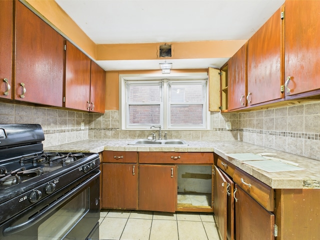 4931 S Knox Ave, Chicago, IL 60632 - kitchen with black gas stove, light tile patterned flooring, decorative backsplash, and brown cabinets