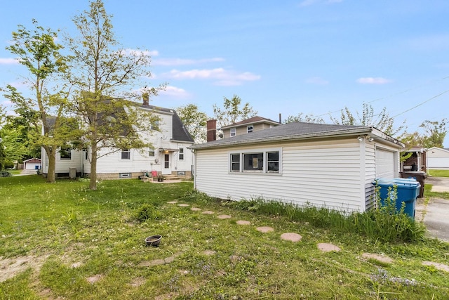 657 1st St, Crete, IL 60417 - rear view of house with a yard, an attached garage, and an outbuilding