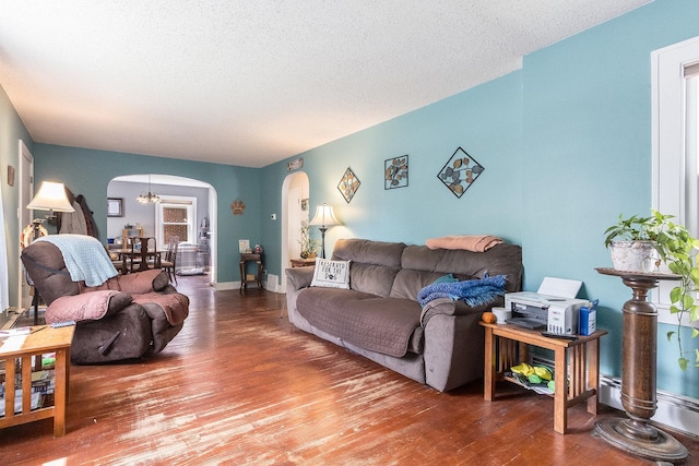 657 1st St, Crete, IL 60417 - living area with arched walkways, hardwood / wood-style flooring, a textured ceiling, and a chandelier