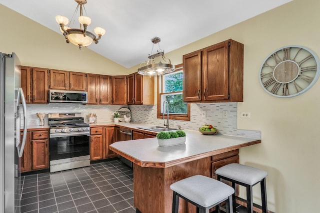 12976 W 21st St, Wadsworth, IL 60083 - kitchen with stainless steel appliances, a peninsula, a chandelier, lofted ceiling, and decorative backsplash
