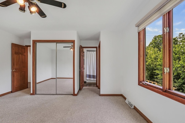 12976 W 21st St, Wadsworth, IL 60083 - unfurnished bedroom featuring multiple windows, light carpet, and a closet