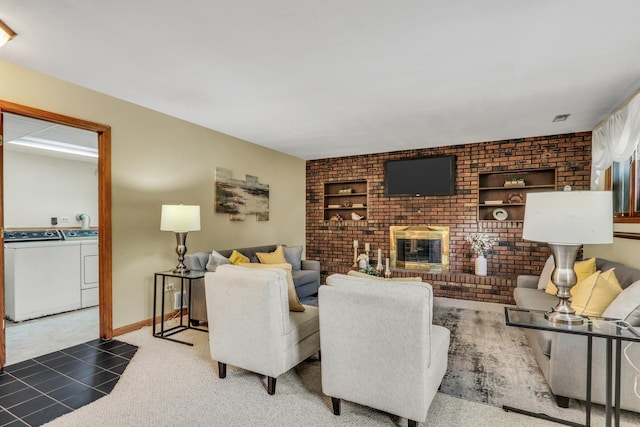 12976 W 21st St, Wadsworth, IL 60083 - living area featuring separate washer and dryer, brick wall, and a brick fireplace