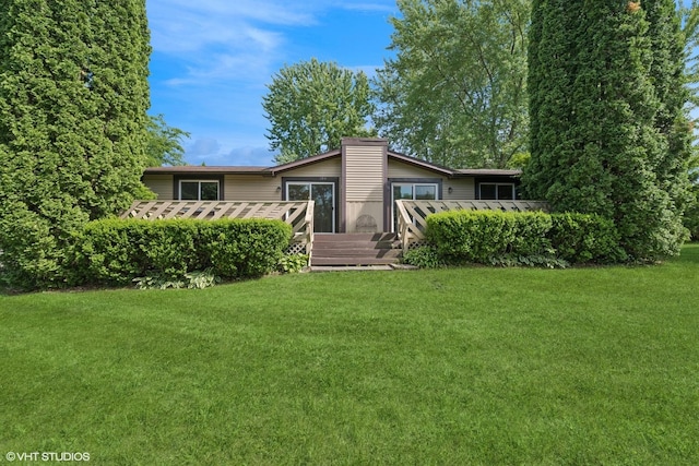 104 Hastings Way SW, Poplar Grove, IL 61065 - rear view of house featuring a wooden deck, a lawn, and a chimney