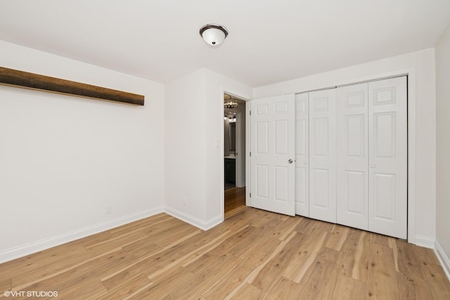 104 Hastings Way SW, Poplar Grove, IL 61065 - unfurnished bedroom featuring light wood-style floors and a closet