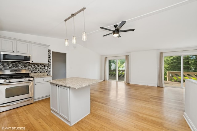 104 Hastings Way SW, Poplar Grove, IL 61065 - kitchen featuring appliances with stainless steel finishes, ceiling fan, lofted ceiling, tasteful backsplash, and open floor plan