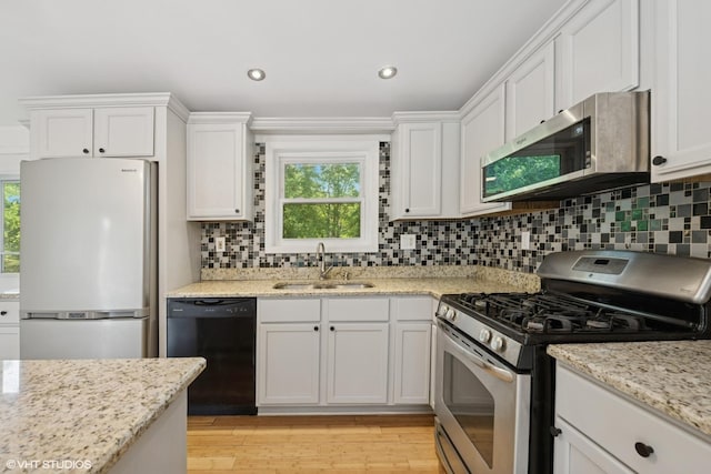104 Hastings Way SW, Poplar Grove, IL 61065 - kitchen with stainless steel appliances, white cabinetry, decorative backsplash, and recessed lighting