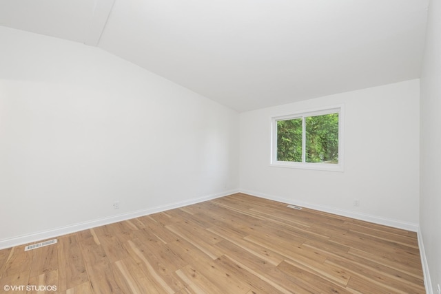 104 Hastings Way SW, Poplar Grove, IL 61065 - unfurnished room with lofted ceiling and light wood-type flooring