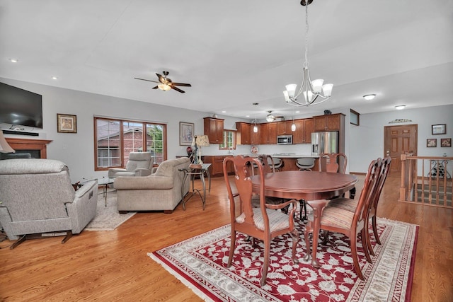 11186 188th Pl, Mokena, IL 60448 - dining room with a chandelier, ceiling fan, light wood-style floors, recessed lighting, and a fireplace