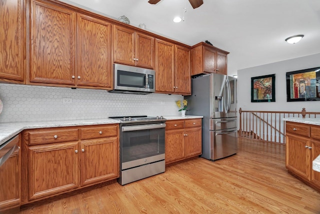 11186 188th Pl, Mokena, IL 60448 - kitchen featuring stainless steel appliances, brown cabinets, light wood finished floors, and ceiling fan