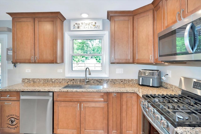 14727 Central Park Ave, Midlothian, IL 60445 - kitchen featuring stainless steel appliances, light stone counters, and brown cabinetry