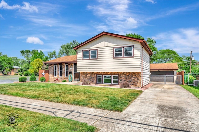 14727 Central Park Ave, Midlothian, IL 60445 - split level home featuring a gate, brick siding, a garage, and an outbuilding
