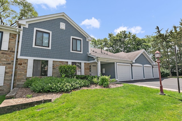 403 Sandalwood Ln Unit C1, Schaumburg, IL 60193 - view of front of house featuring stone siding, asphalt driveway, a front lawn, and an attached garage