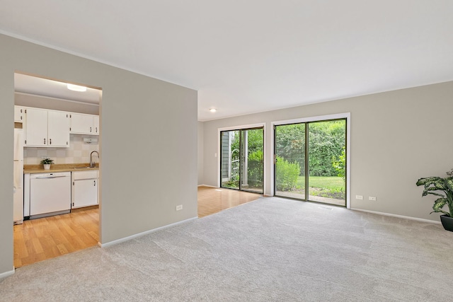 403 Sandalwood Ln Unit C1, Schaumburg, IL 60193 - unfurnished living room featuring light carpet and a sink