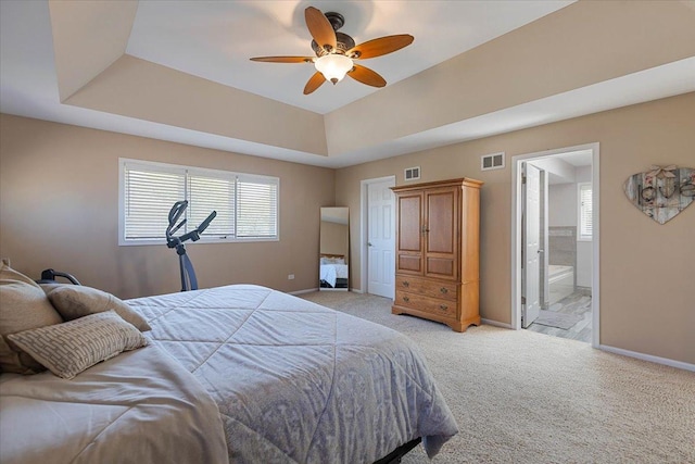 13907 W Big Run Ln, Homer Glen, IL 60491 - bedroom featuring light colored carpet, a tray ceiling, ensuite bathroom, and ceiling fan
