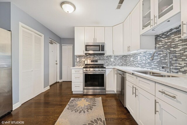 5862 N Lincoln Ave Unit 3A, Chicago, IL 60659 - kitchen featuring appliances with stainless steel finishes, dark wood-type flooring, and backsplash