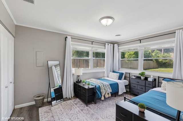 14928 Millard Ave, Midlothian, IL 60445 - bedroom featuring light wood-style flooring, crown molding, and a closet