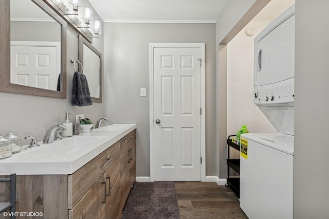14928 Millard Ave, Midlothian, IL 60445 - bathroom featuring stacked washing machine and dryer, wood finished floors, double vanity, and crown molding