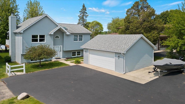 1905 E Grand Ave, Lindenhurst, IL 60046 - view of front facade featuring a chimney, a garage, and a shingled roof