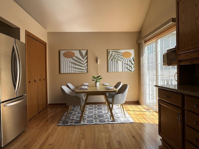 1905 E Grand Ave, Lindenhurst, IL 60046 - dining room featuring light wood finished floors and vaulted ceiling