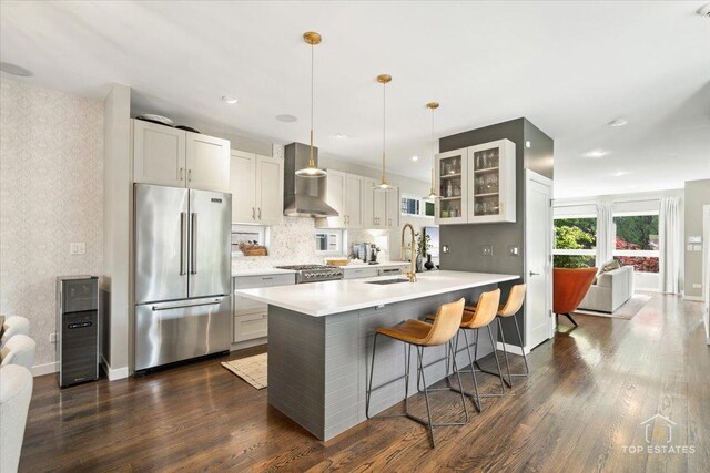 3800 N Christiana Ave, Chicago, IL 60618 - kitchen with high quality fridge, wall chimney exhaust hood, wallpapered walls, dark wood-type flooring, and light countertops
