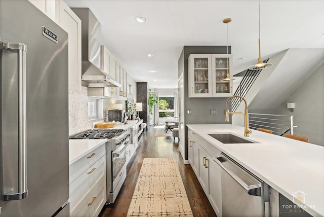 3800 N Christiana Ave, Chicago, IL 60618 - kitchen with high quality appliances, wall chimney exhaust hood, dark wood-type flooring, light countertops, and glass insert cabinets