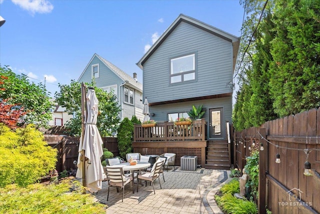 3800 N Christiana Ave, Chicago, IL 60618 - rear view of house with a deck, a patio, a fenced backyard, and outdoor dining area