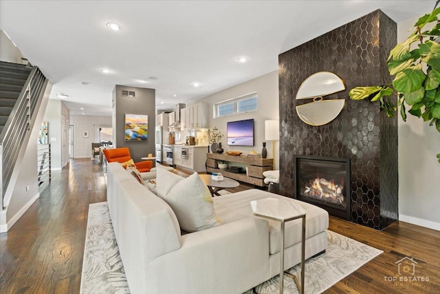 3800 N Christiana Ave, Chicago, IL 60618 - living area with stairway, a large fireplace, wood finished floors, and recessed lighting
