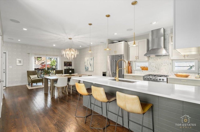3800 N Christiana Ave, Chicago, IL 60618 - kitchen featuring wall chimney exhaust hood, range, dark wood-style flooring, light countertops, and high quality fridge