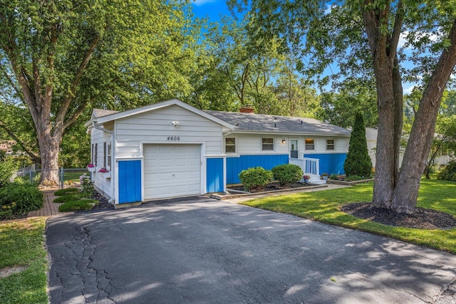 4606 Willow Ln, Mchenry, IL 60050 - view of front of house with a garage, asphalt driveway, and a chimney