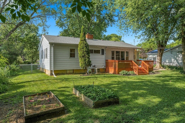 4606 Willow Ln, Mchenry, IL 60050 - rear view of property featuring a vegetable garden, a chimney, a fenced backyard, and a deck