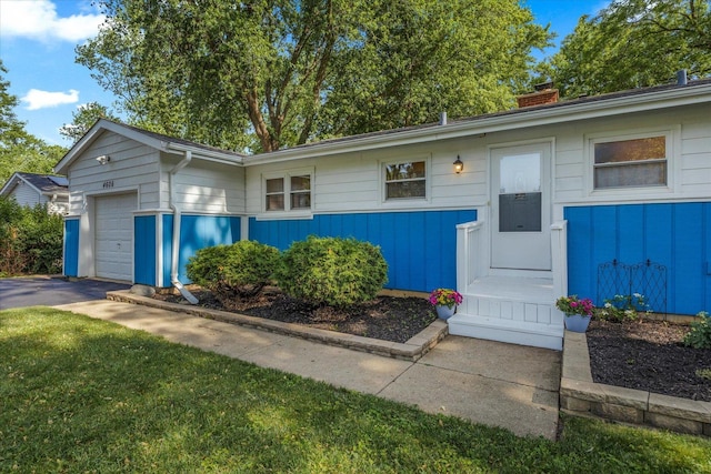 4606 Willow Ln, Mchenry, IL 60050 - ranch-style home featuring a chimney, a garage, board and batten siding, and driveway