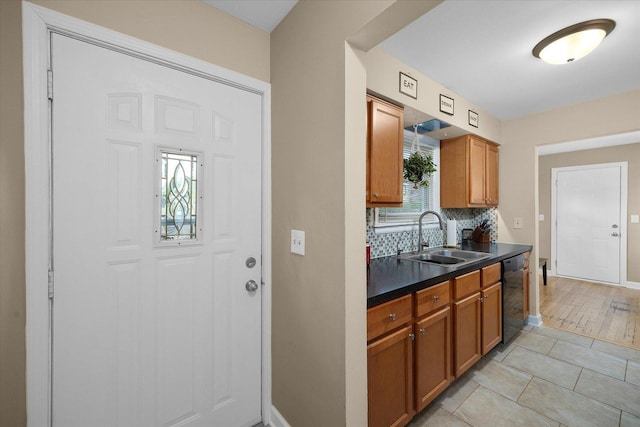 4606 Willow Ln, Mchenry, IL 60050 - kitchen with dishwasher, dark countertops, decorative backsplash, and brown cabinetry