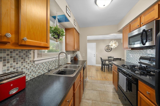 4606 Willow Ln, Mchenry, IL 60050 - kitchen with black appliances, dark countertops, brown cabinetry, and tasteful backsplash