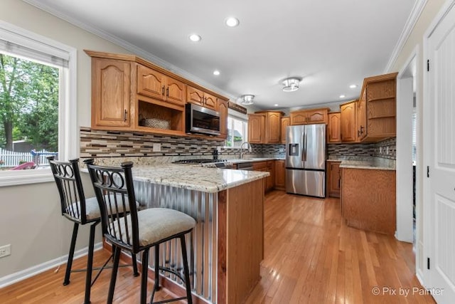 987 Split Rail Dr, Carol Stream, IL 60188 - kitchen featuring open shelves, appliances with stainless steel finishes, a peninsula, plenty of natural light, and crown molding