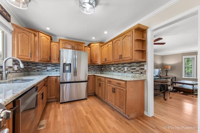 987 Split Rail Dr, Carol Stream, IL 60188 - kitchen with appliances with stainless steel finishes, light wood finished floors, light stone counters, crown molding, and decorative backsplash