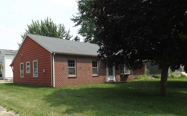 1412 11th Ave, Sterling, IL 61081 - view of side of home with a yard, a chimney, brick siding, and roof with shingles