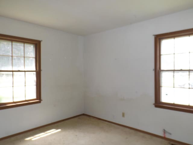 1412 11th Ave, Sterling, IL 61081 - spare room with plenty of natural light and light carpet