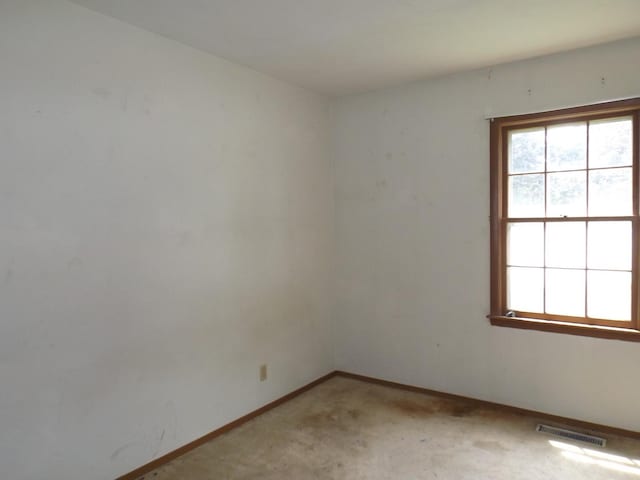 1412 11th Ave, Sterling, IL 61081 - spare room featuring baseboards and light carpet