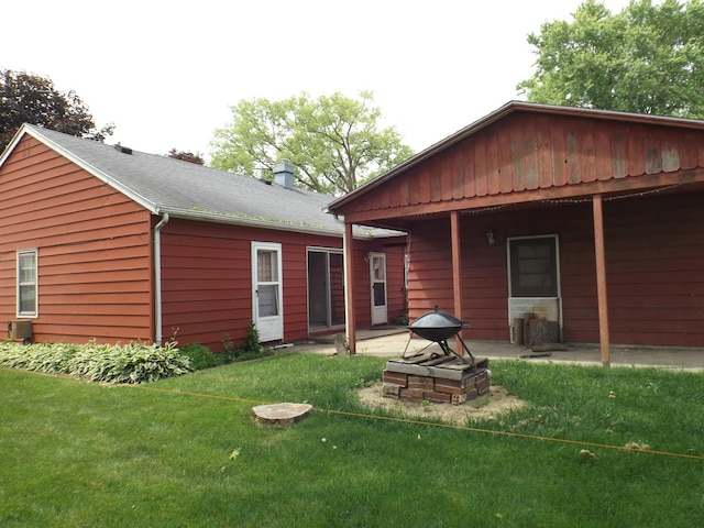 1412 11th Ave, Sterling, IL 61081 - rear view of house featuring a lawn and a patio area